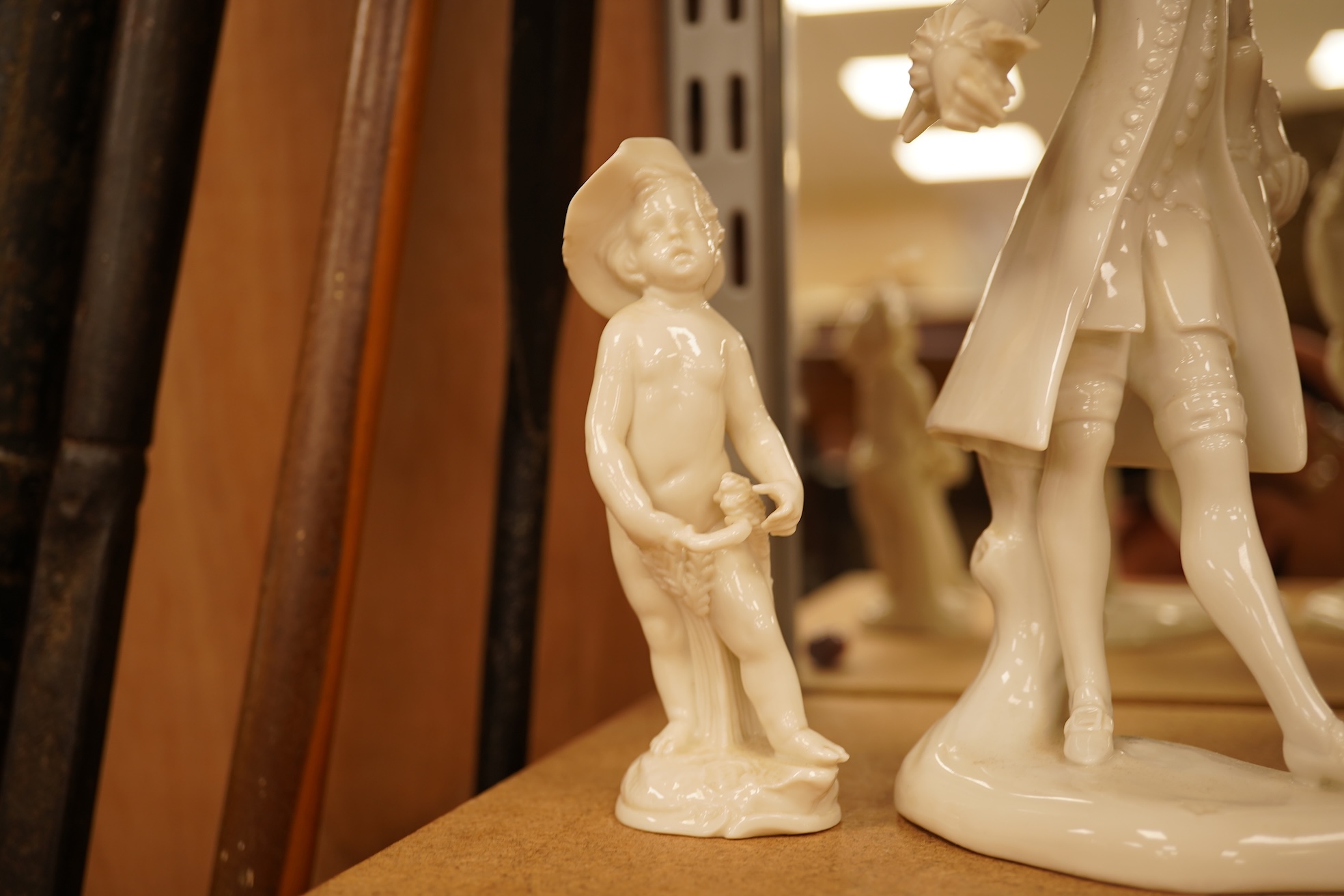 Two Nymphenberg white glazed figures, after Bustelli and two similar cherubs (4) figure 19 cm high